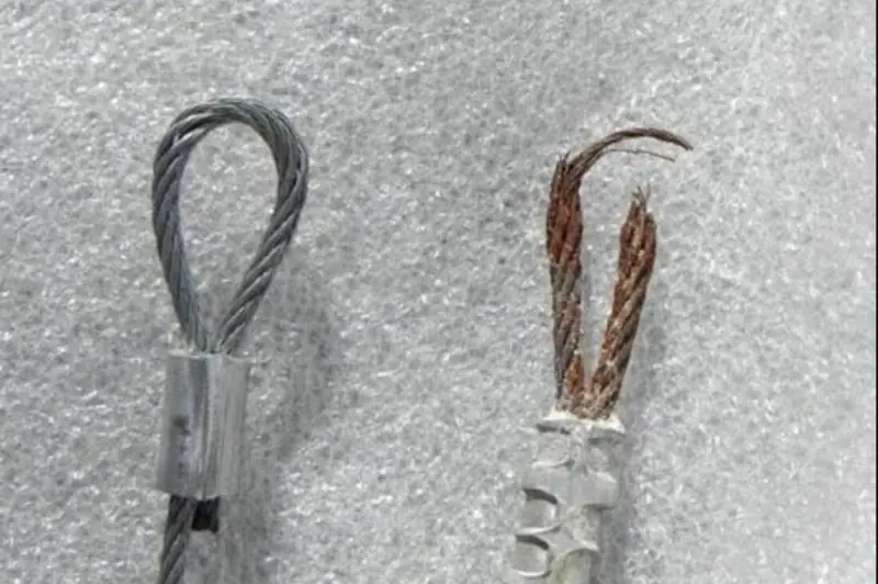 DPS Garage Doors comparison of a new garage door lifting cable beside a frayed snapped cable being replaced in the GTA