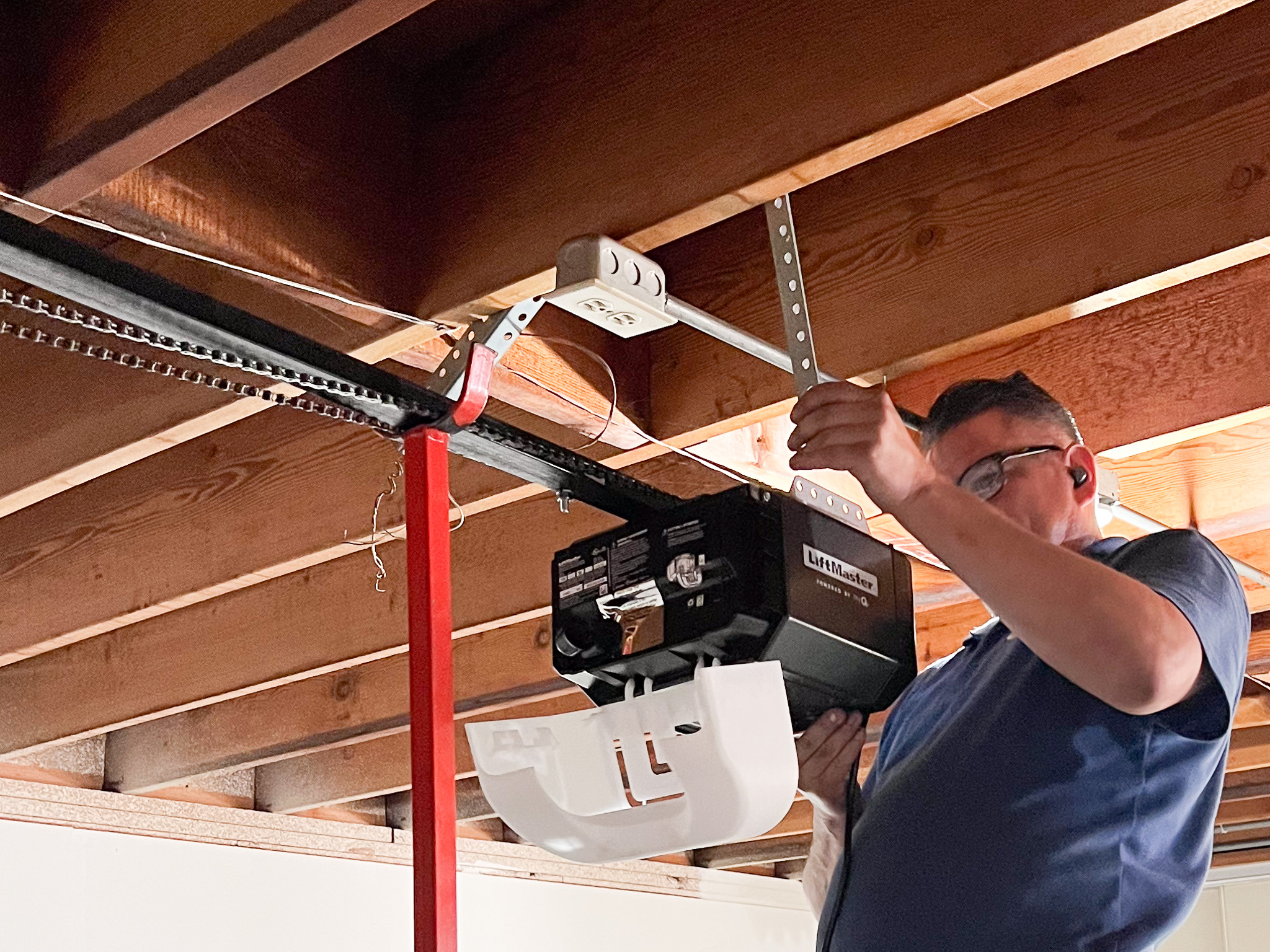 DPS Garage Doors technician installing a LiftMaster garage door opener in Toronto