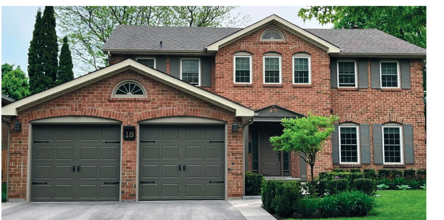 Coach house carriage-style garage door with an arched window row