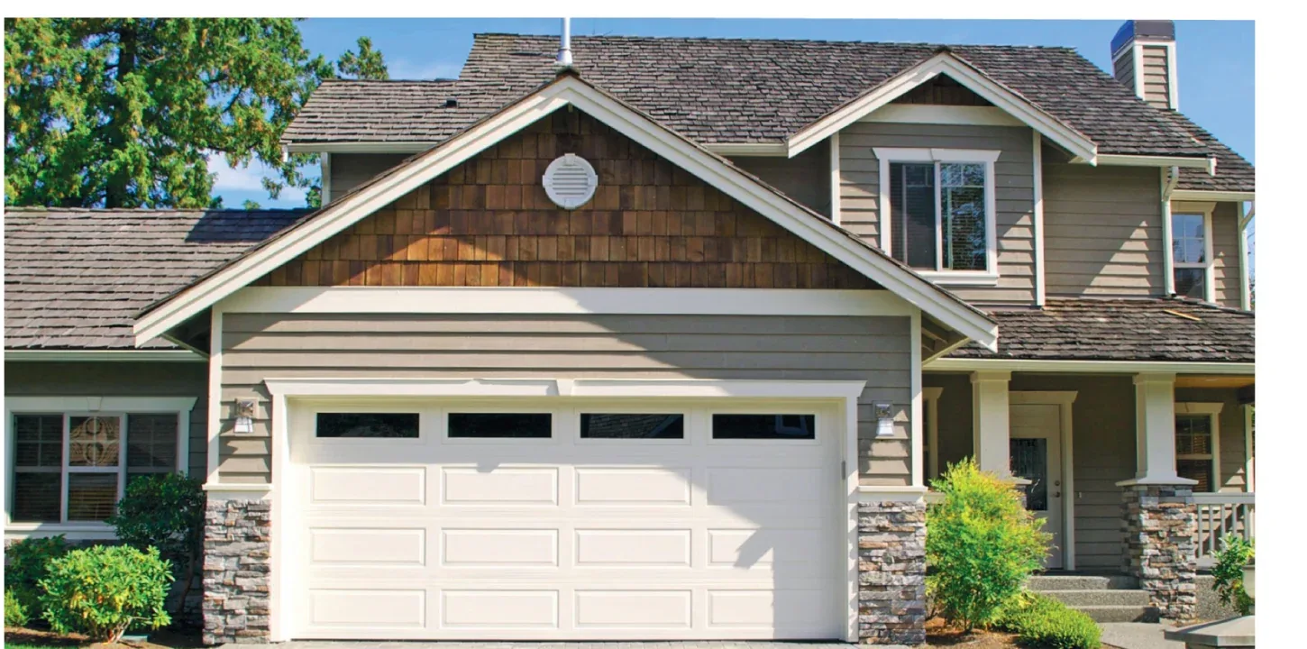 Long raised-panel insulated garage door on a GTA home